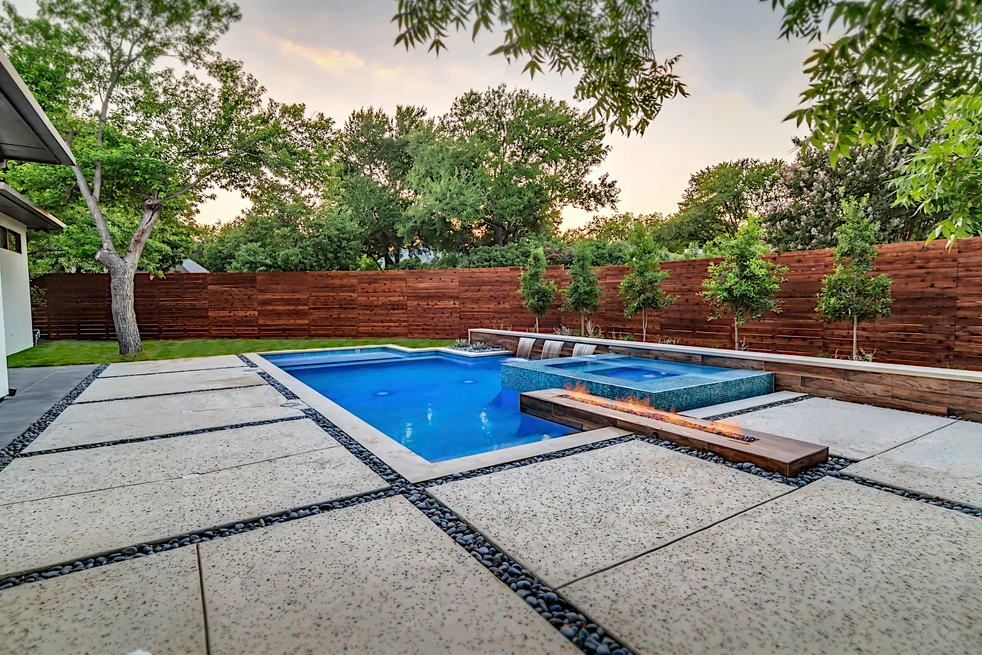 a pool with custom fire and water features in dallas